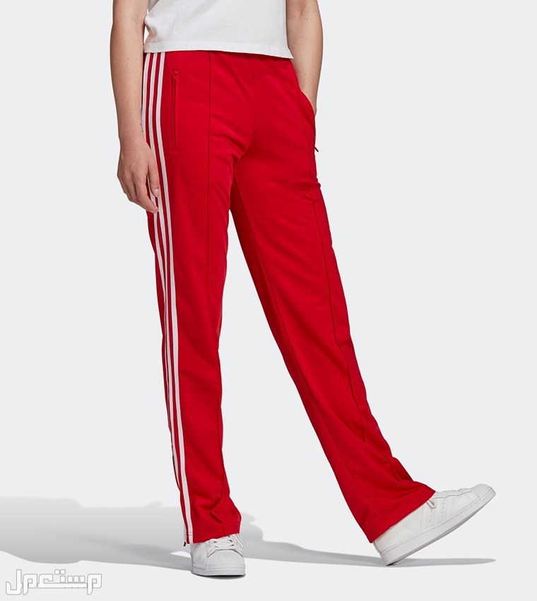 نصائح لاختيار القطع الأساسية للملابس الرياضية النسائية في السعودية سروال ADIDAS Adidcolor Classics Firebird Primeblue Track Pants باللون الأحمر