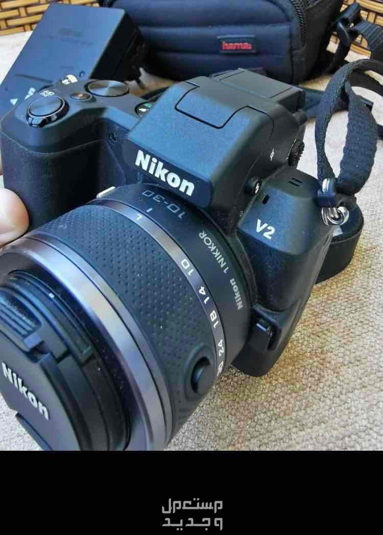 Nikon camera, model 1v2, UK imported, price on Amazon is $474, which means 24856 in Egyptian dollars, with the camera, charger, holder bag