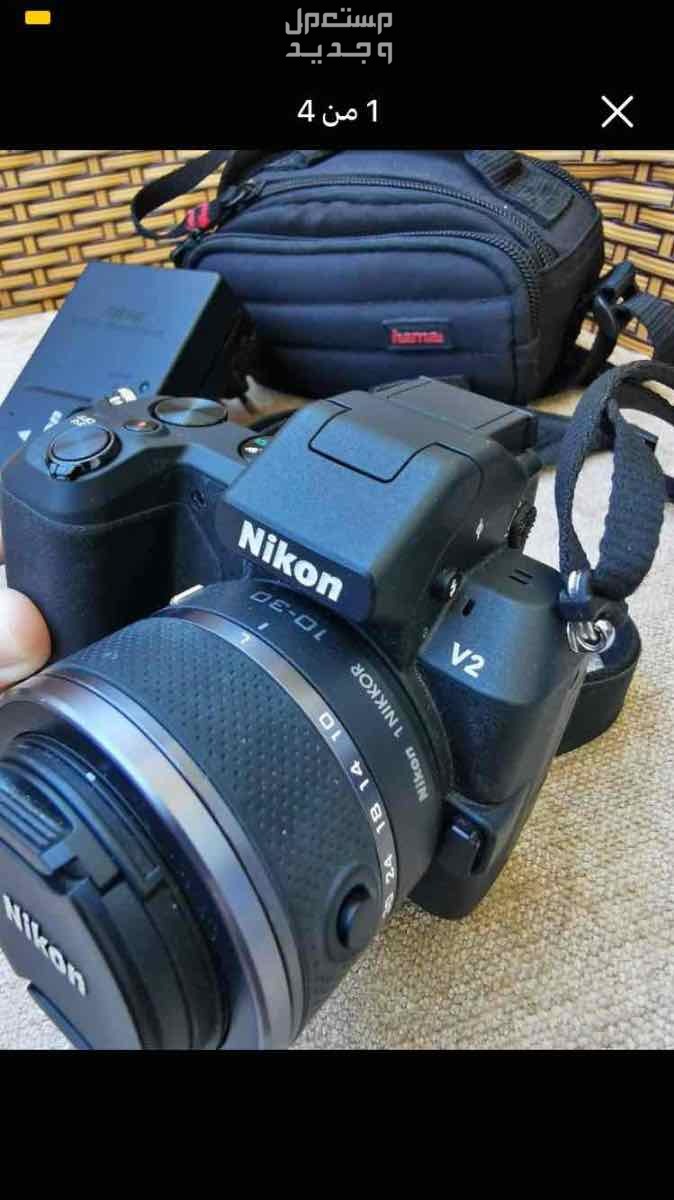 Nikon camera, model 1v2, UK imported, price on Amazon is $474, which means 24856 in Egyptian dollars, with the camera, charger, holder bag