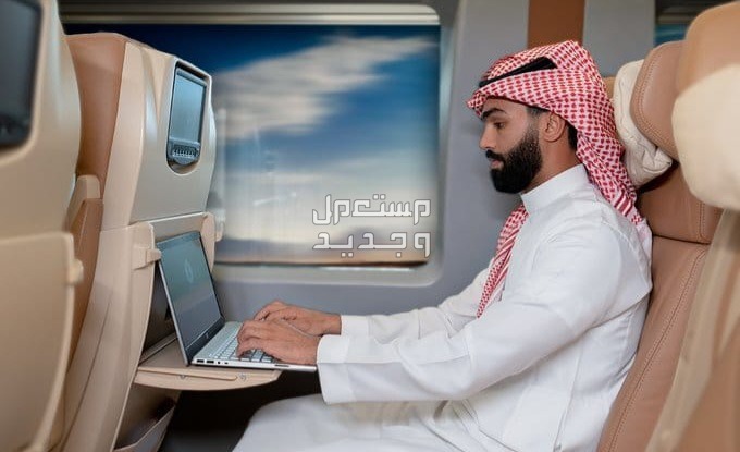مواعيد رحلات قطار الحرمين وأسعارها لعام 1446 في الإمارات العربية المتحدة رجل سعودي يستخدم اللاب توب في قطار الحرمين